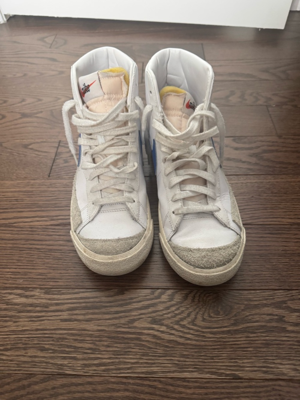 Nike White High-Top Sneakers with Blue Swoosh